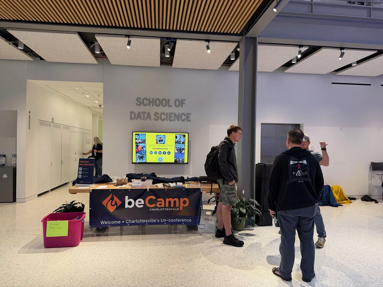 The registration table under the School of Data Science sign, a beCamp welcome banner in front