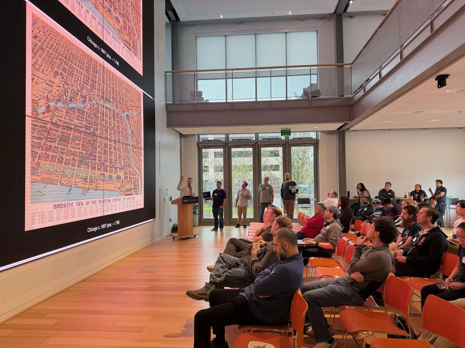 A session in the main hall, a large historic city map filling the video wall